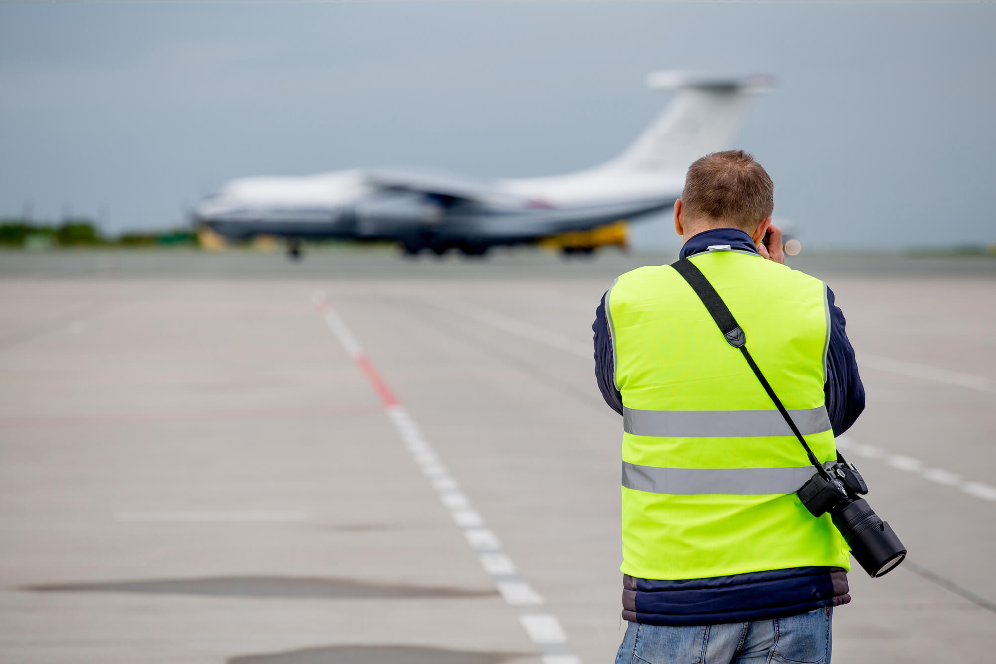 Man taking photos of an aeroplane